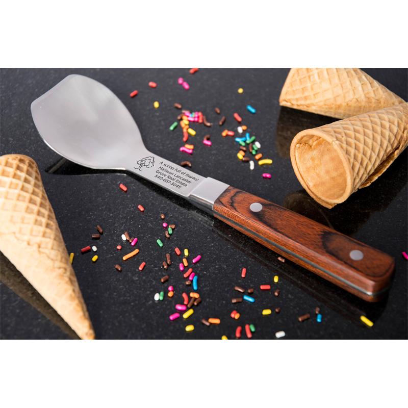 Engraved stainless steel ice cream paddle with rosewood handle.